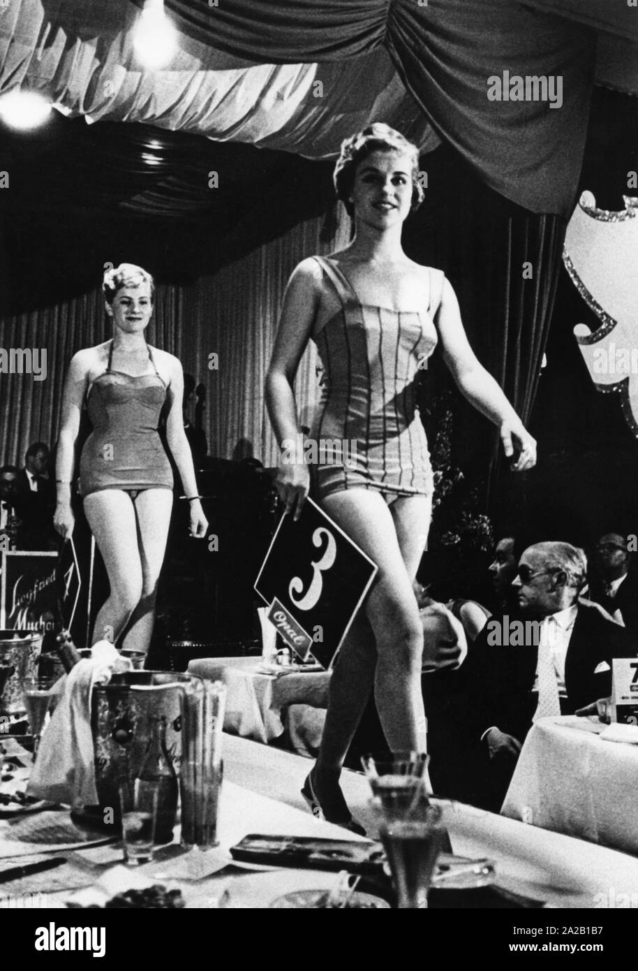 Two candidates present themselves on the catwalk during the Miss Germany election in 1958 in the Kurhaus of Baden-Baden. Stock Photo