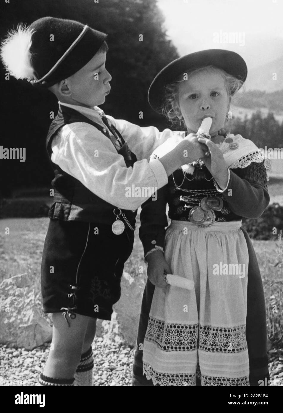 Upper Bavarian children eat an ice cream. Undated photo, probably in the 1960s. Stock Photo
