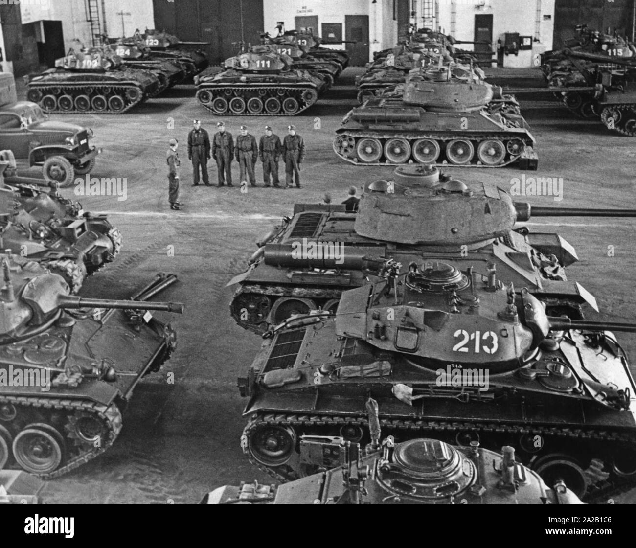 Tank in a hall of an armored unit of the newly formed Armed Forces. In the picture tanks of American and Russian origin. Undated photo, probably in the 1950s. Stock Photo