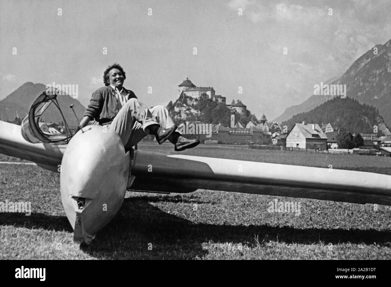 The picture shows the pilot of a glider after landing in a meadow near Kufstein. The picture is probably from the 1950s. Stock Photo