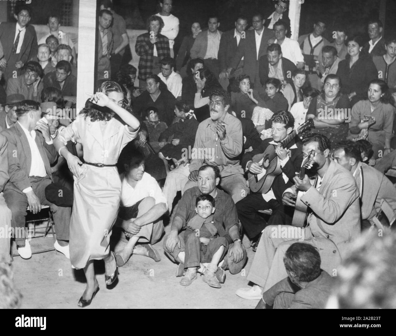 Every May, Sinti and Roma from all over the world go on pilgrimage to Les Saintes Maries de la Mer, southern France, to worship their patron saint, Saint Sara. Here, Sinti and Roma while playing music and dancing. Undated photo, probably from the 1950s. Stock Photo