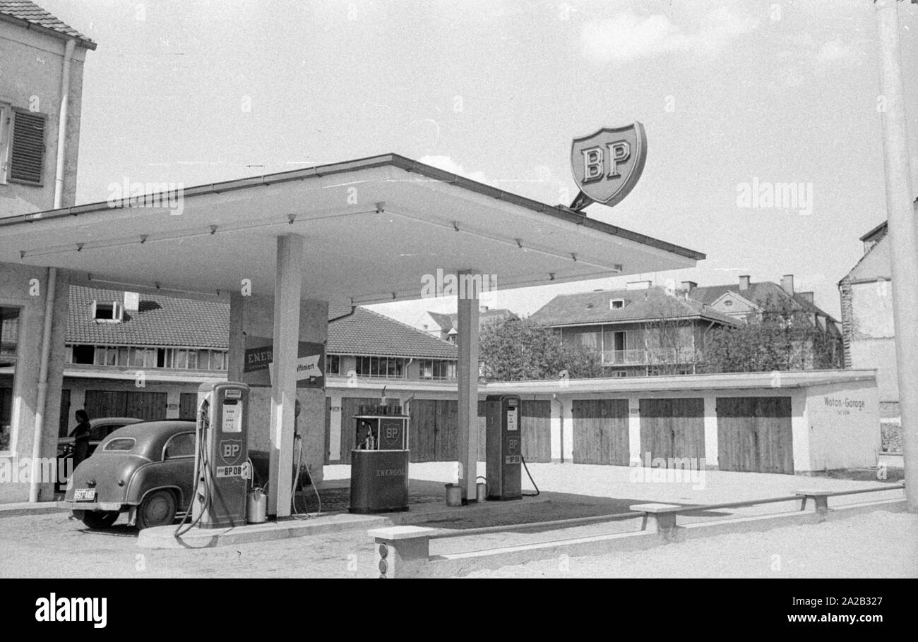 The picture shows a BP gas station in a rural region of Austria, along with some garages. The sign on the flat roof of the gas station and the advertising sign at the entrance show the BP logo from this period. Stock Photo