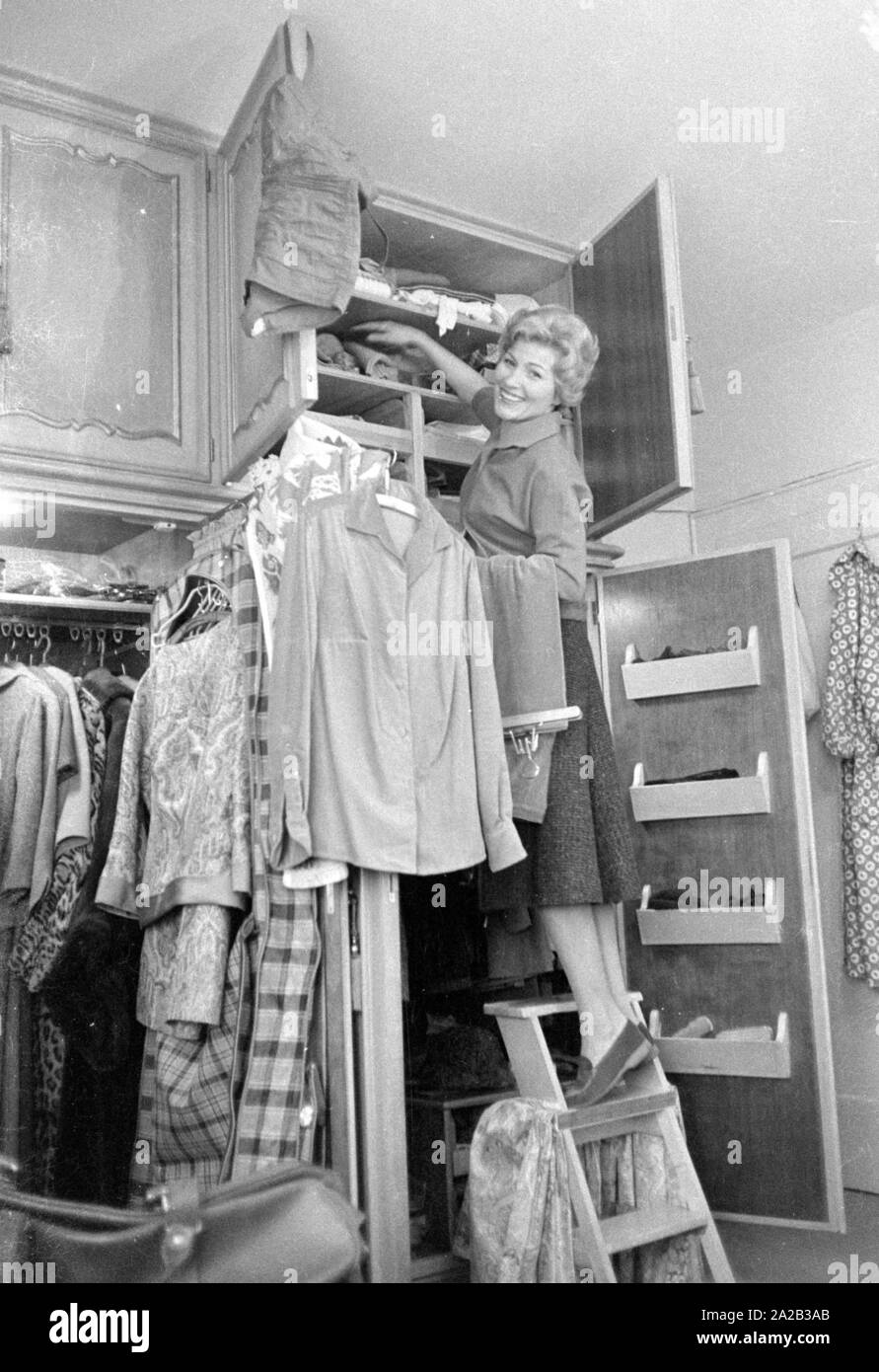 The singer and actress stands in front of her large, open wardrobe and  arranges clothes Stock Photo - Alamy