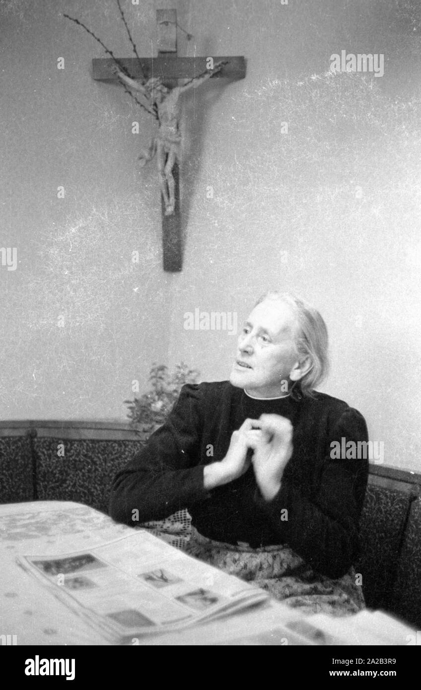 Anna Stadler from Gundelfingen was the first German woman to be awarded the Order of the French Legion of Honor in 1959. During the Second World War, she looked after French prisoners of war in secret and helped some of them to flee shortly before the end of the war. The picture shows her with a newspaper at the table of her living room. Stock Photo
