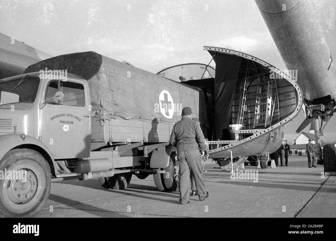 A Noratlas of the Bundesluftwaffen is loaded with auxiliary material destined for Morocco on the Neubiberg Air Base. During a so-called paralysis epidemic in Morocco, a Nord Noratlas aircraft of the Lufttransportgeschwader 61 of the Bundeswehr transports auxiliary material, including beds, to Morocco. Due to the operating range of the engine, the flights went via Madrid and Gibraltar to Africa. The cause of the paralysis epidemic was poisoned cooking oil (tri-acryl-phosphorus poisoning) which the patients partook at the Mouloud festival. Stock Photo