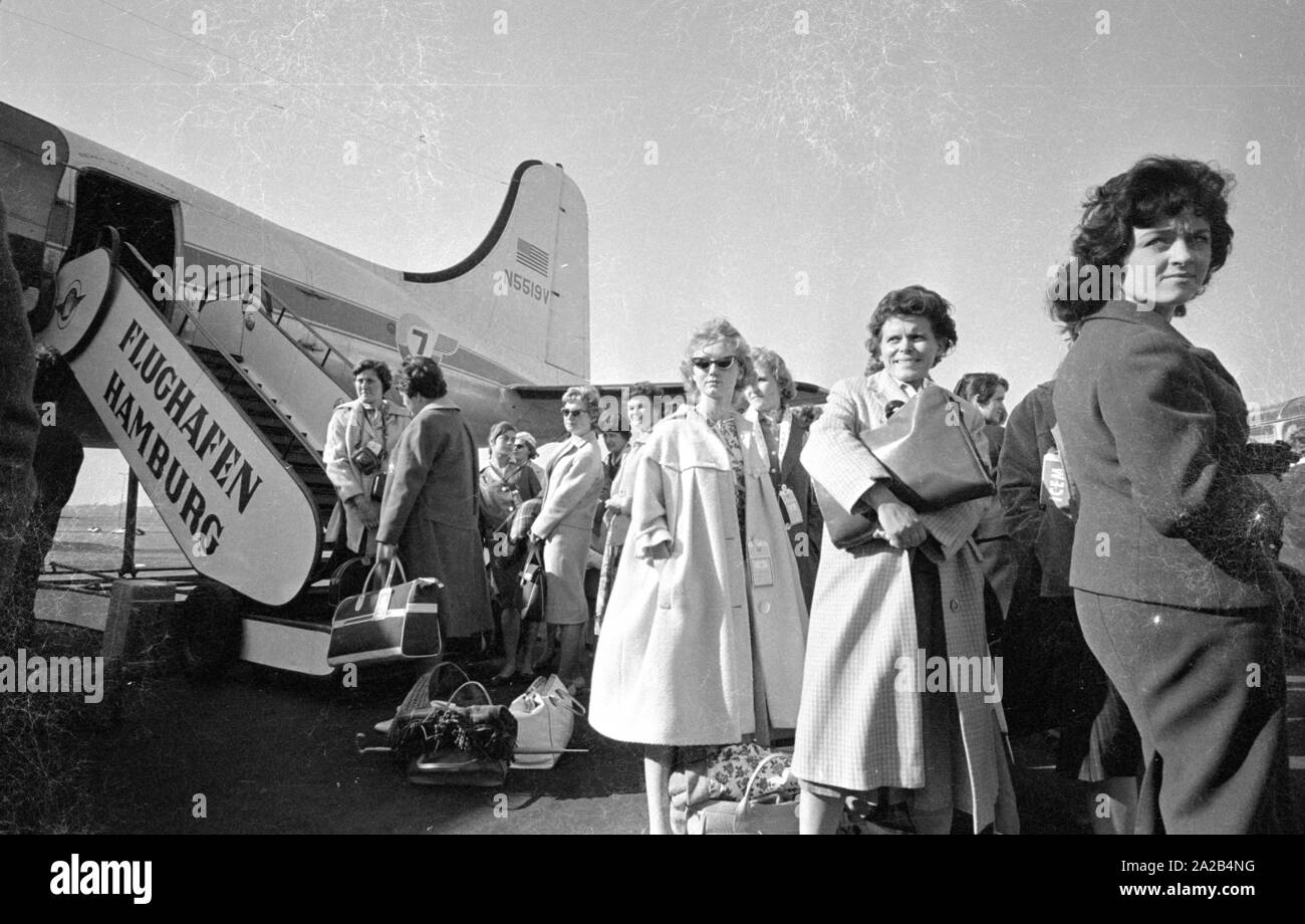 A group of young German women just before boarding a plane to Melbourne. They had decided to emigrate to Australia.  At that time the Australian government  attracted immigrants by offering them financial support and many young women and men accepted the offers. Stock Photo