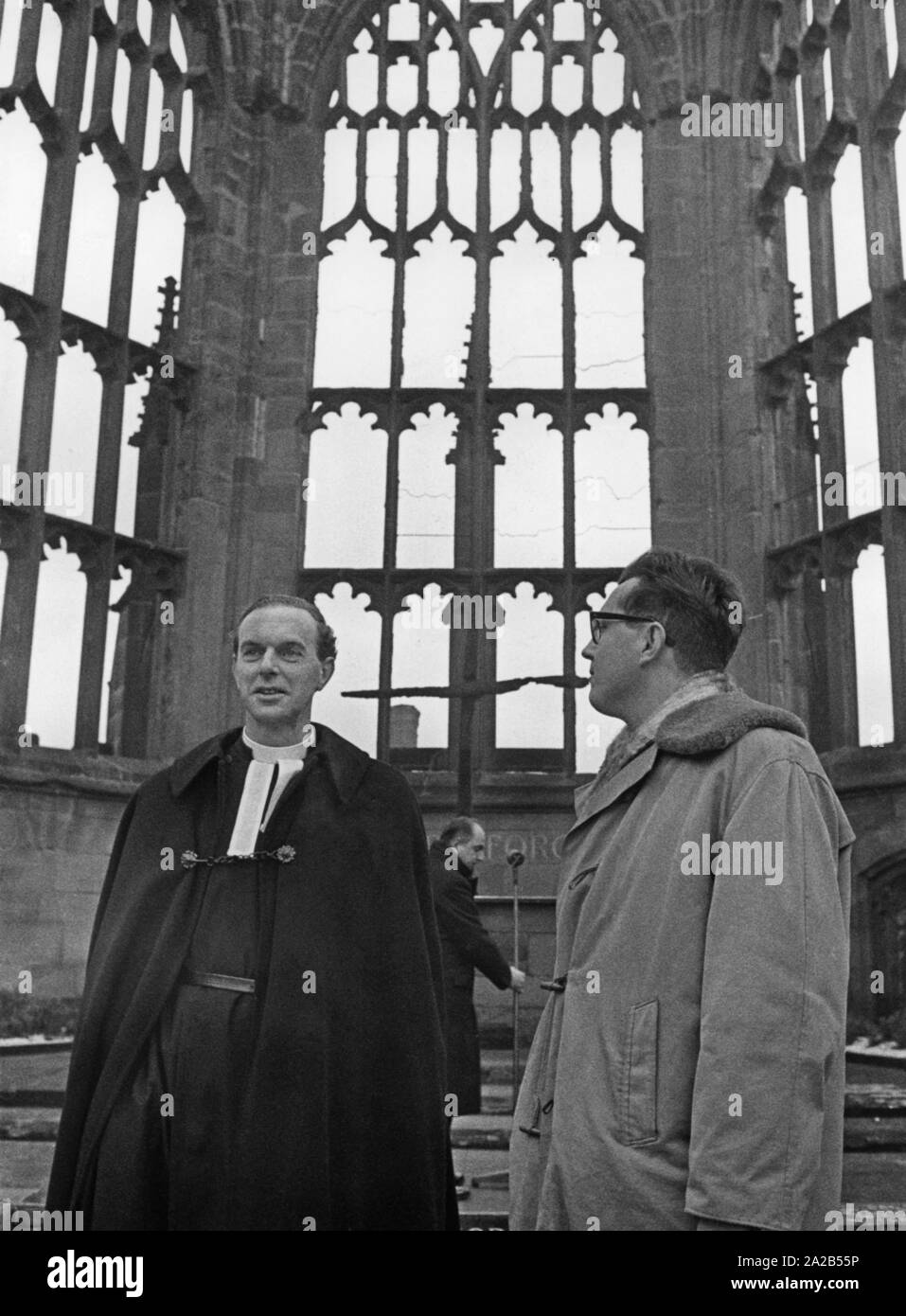 Reverend Bill Williams, pastor of the destroyed Coventry Cathedral (left), invites Bishop Otto Dibelius (not pictured) to visit Coventry on the occasion of anti-Semitic riots. Stock Photo