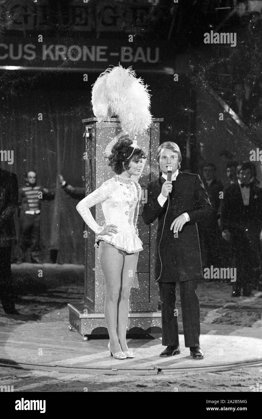 In the program of the charity TV show 'Die Goldene Zehn' (also known as 'Stars in der Manege') the actors Fritz Wepper and Uschi Glas appear as a magician and assistant. Uschi Glas wears a big feather headdress. The performance was probably the 'disappearance' of Uschi Glas in the closet. Stock Photo