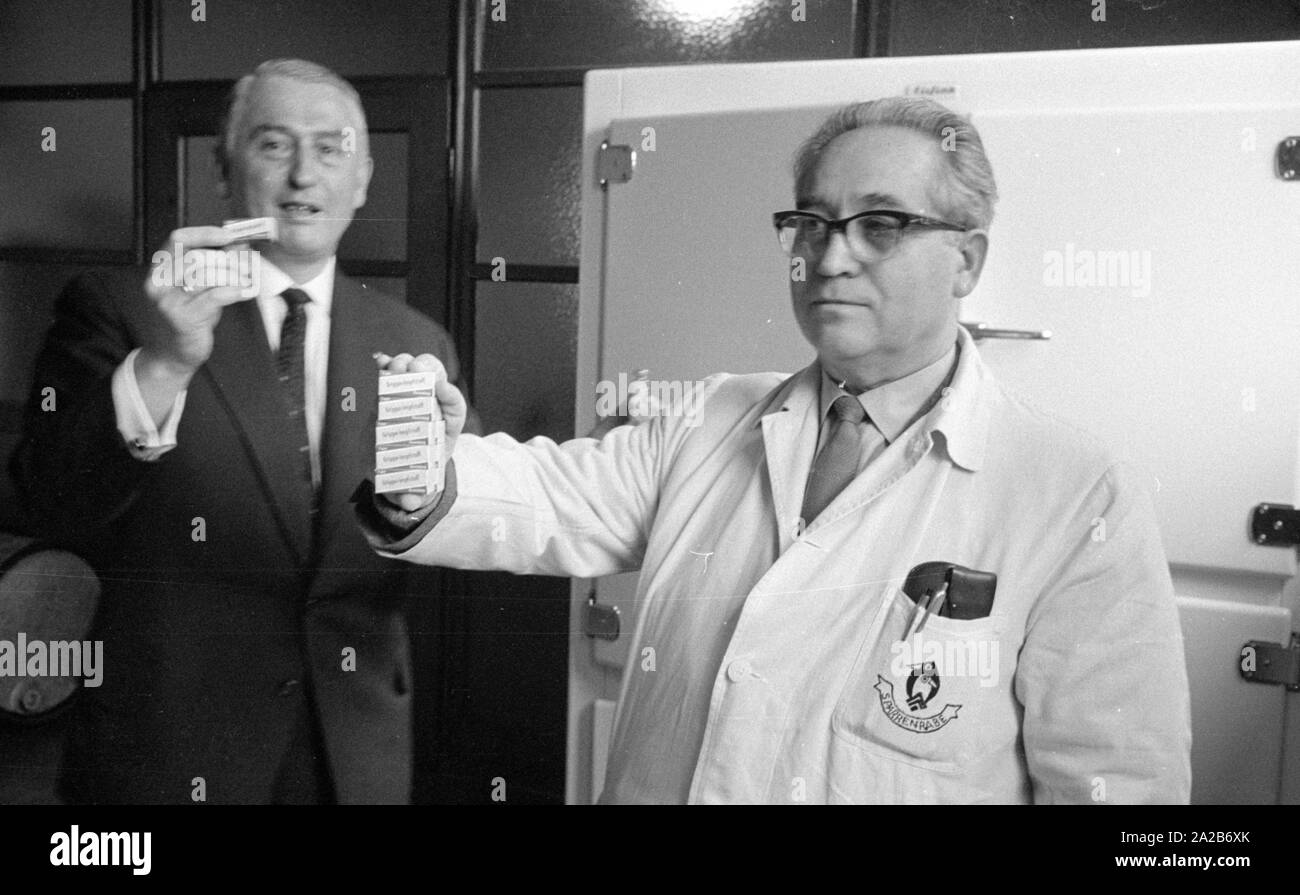 Immunization action in Konstanz with a newly developed flu vaccine of the Ravensberg Chemische Fabrik, two employees with the new vaccine in front of a medicine cabinet. Around 1960 committees recommended the vaccination against influenza viruses for the first time in the Federal Republic of Germany. Stock Photo