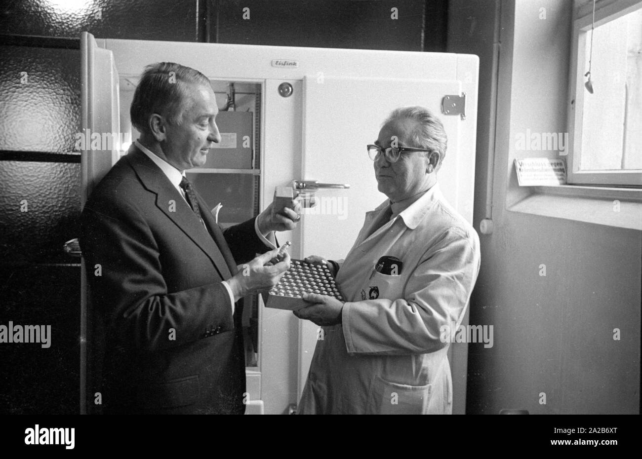 Immunization action in Konstanz with a newly developed flu vaccine of the Ravensberg Chemische Fabrik, two employees with the new vaccine in front of a medicine cabinet. Around 1960 committees recommended the vaccination against influenza viruses for the first time in the Federal Republic of Germany. Stock Photo