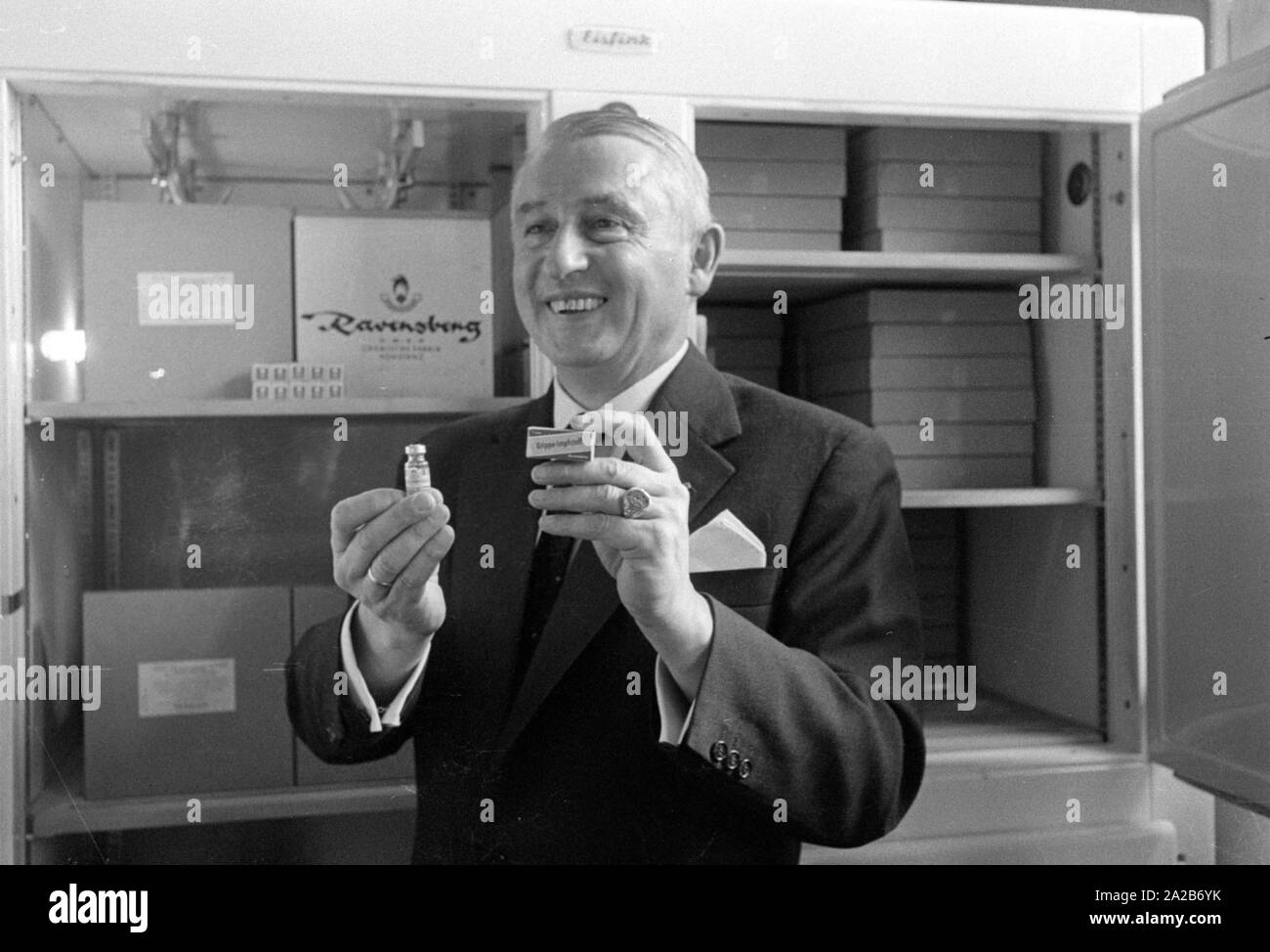 Immunization action in Konstanz with a newly developed flu vaccine of the Ravensberg Chemische Fabrik, an employee of the factory presents the vaccine. Around 1960 committees recommended the vaccination against influenza viruses for the first time in the Federal Republic of Germany. Stock Photo