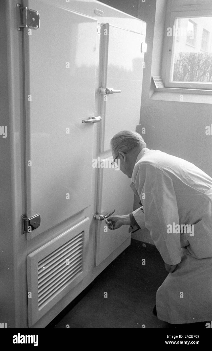 Immunization action in Konstanz with a newly developed flu vaccine of the Ravensberg Chemische Fabrik, an employee of the factory opens a medicine cabinet. Around 1960 committees recommended the vaccination against influenza viruses for the first time in the Federal Republic of Germany. Stock Photo