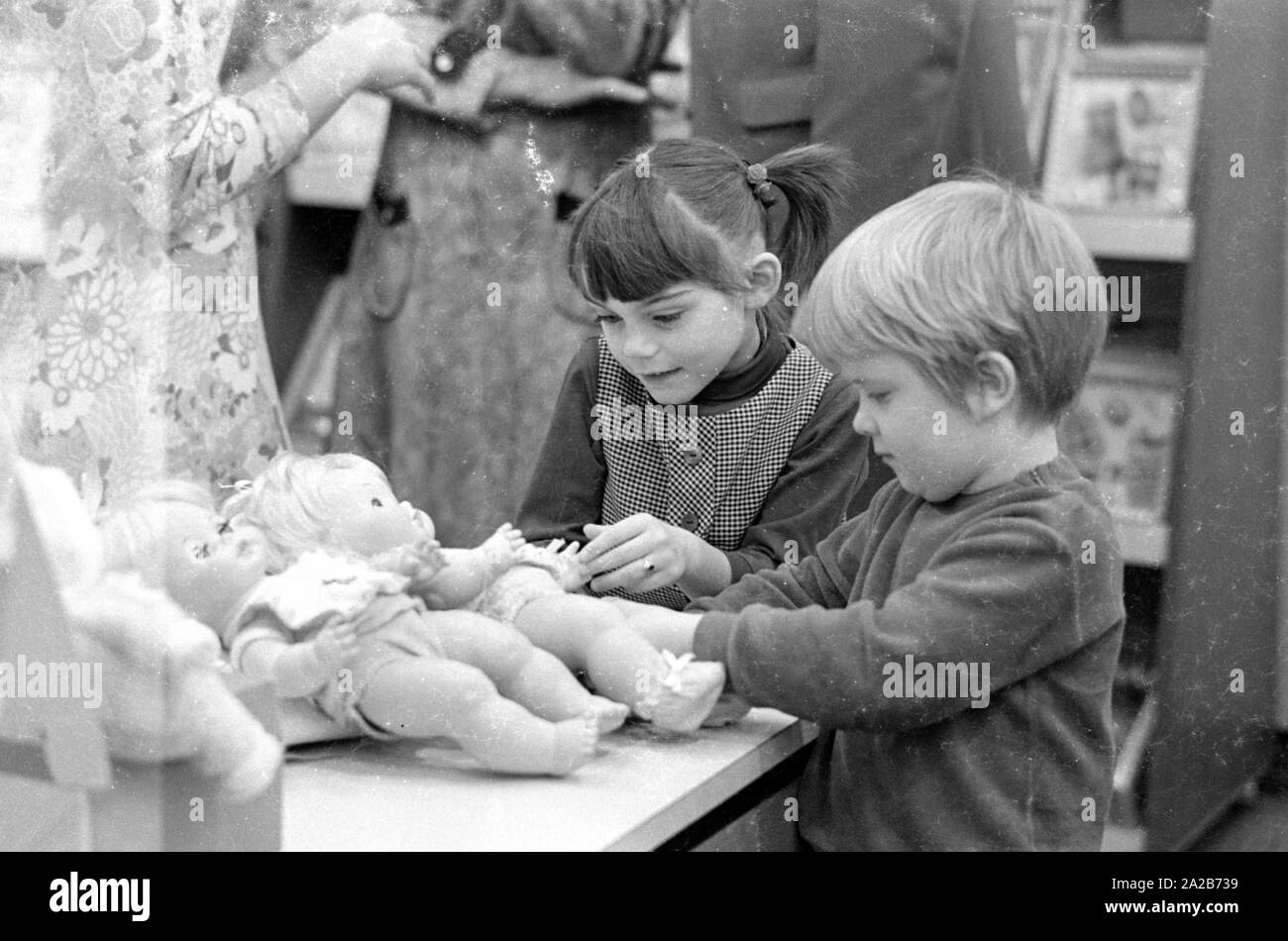 Two children look at dolls of the brand 'Matell' at the Nuremberg Toy Fair, which took place between 06.02.-12.02.1971. Stock Photo