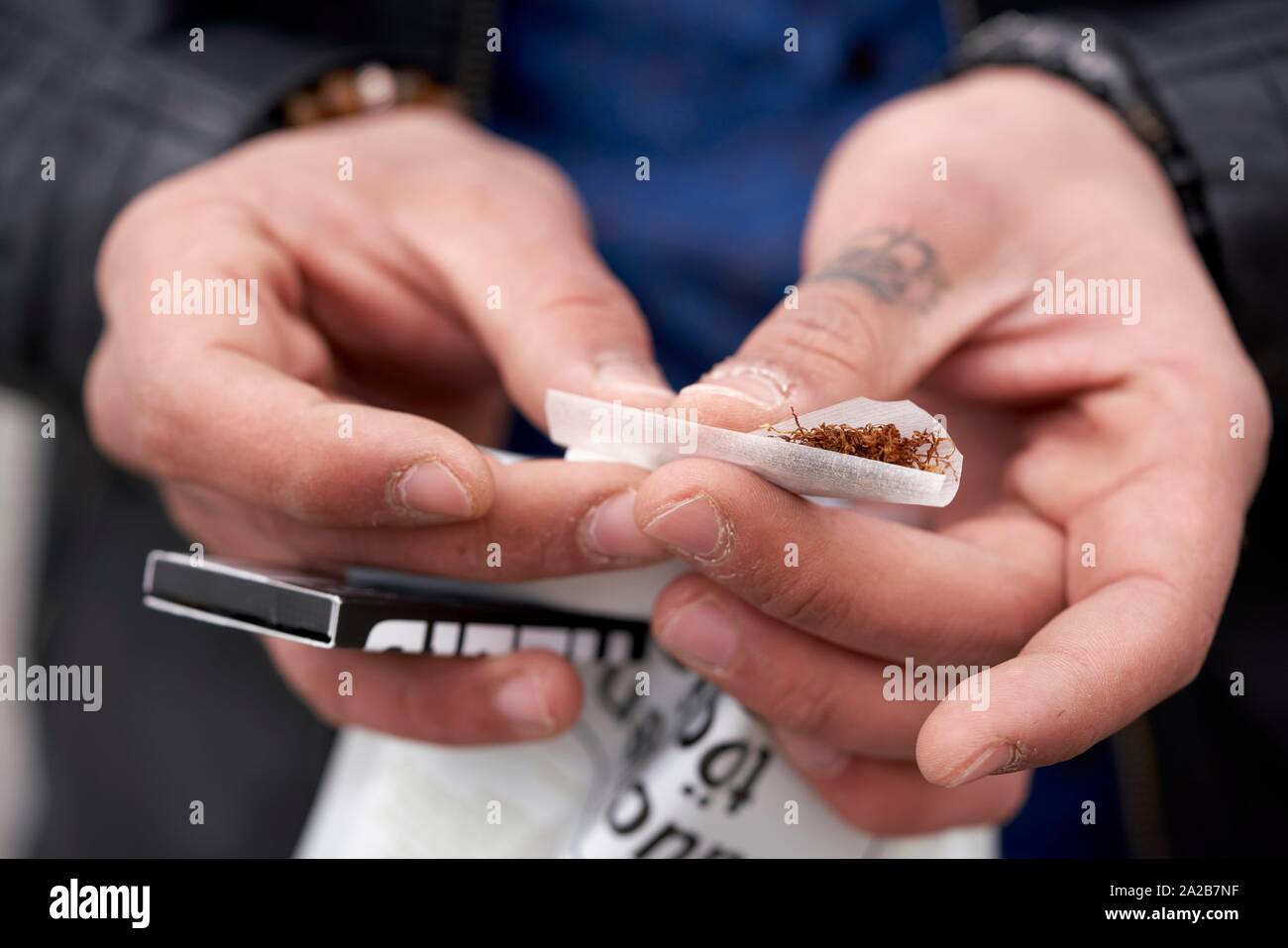 Hands rolling a cigarette, close up Stock Photo Alamy