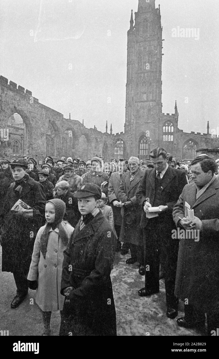Believers have gathered in the ruin of St Michael's Cathedral in Coventry, destroyed by the Germans in World War II, to attend the laying of the foundation stone of the 'International Center for Reconciliation'. German bishop Otto Dibelius traveled to Coventry on the festive occasion. Stock Photo