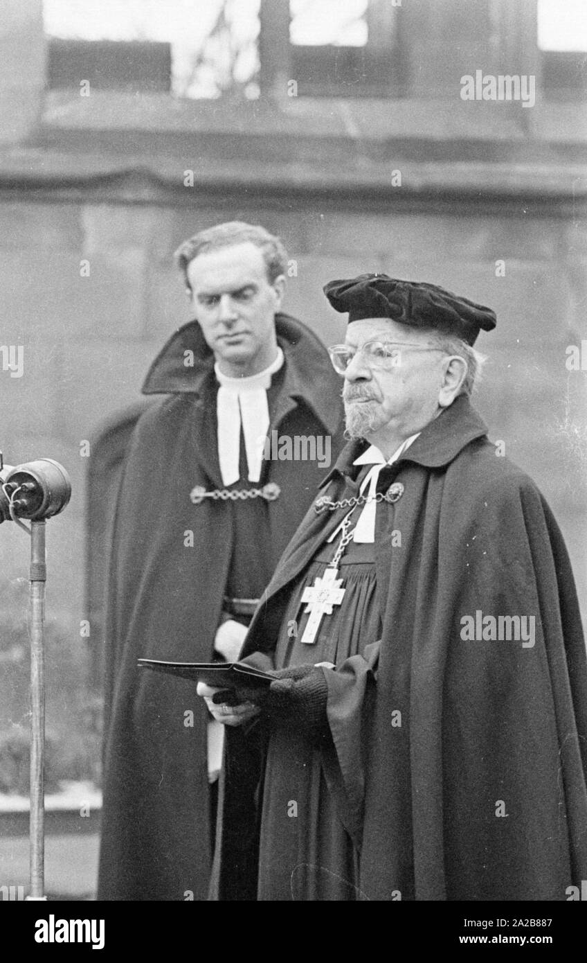 The German bishop, Otto Dibelius, gives a speech in the ruin of the St Michael's Cathedral (Coventry Cathedral) on the occasion of the foundation stone laying of an ' international meeting centre for reconciliation' in the same place. On the left, Reverend Williams, the pastor of the ruined Coventry Cathedral. Stock Photo