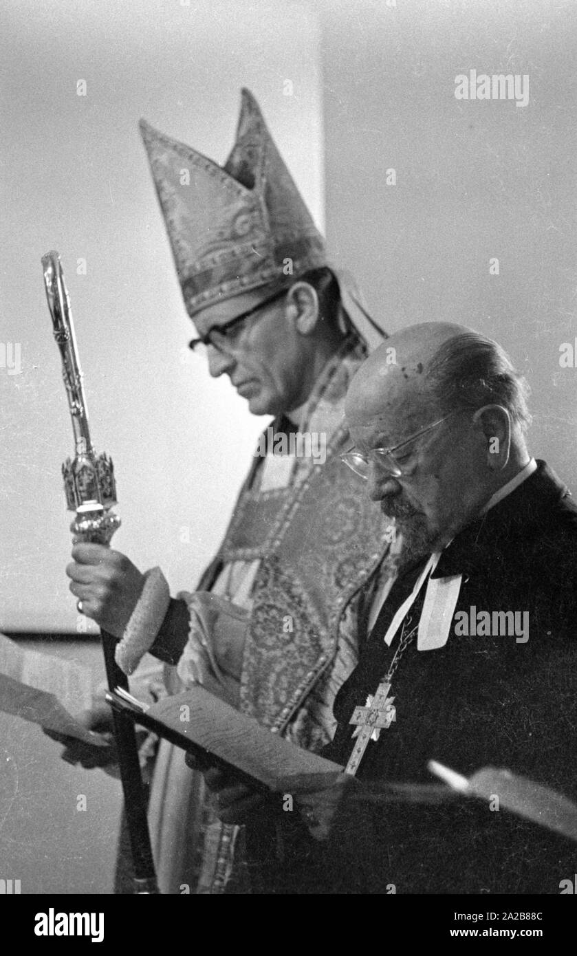 The German bishop, Otto Dibelius, participates at the groundbreaking ceremony  of the 'International Center for Reconciliation' in the ruin of the destroyed St. Michael's Cathedral. Next to him, a clerical dignitary of the Church of England. Stock Photo