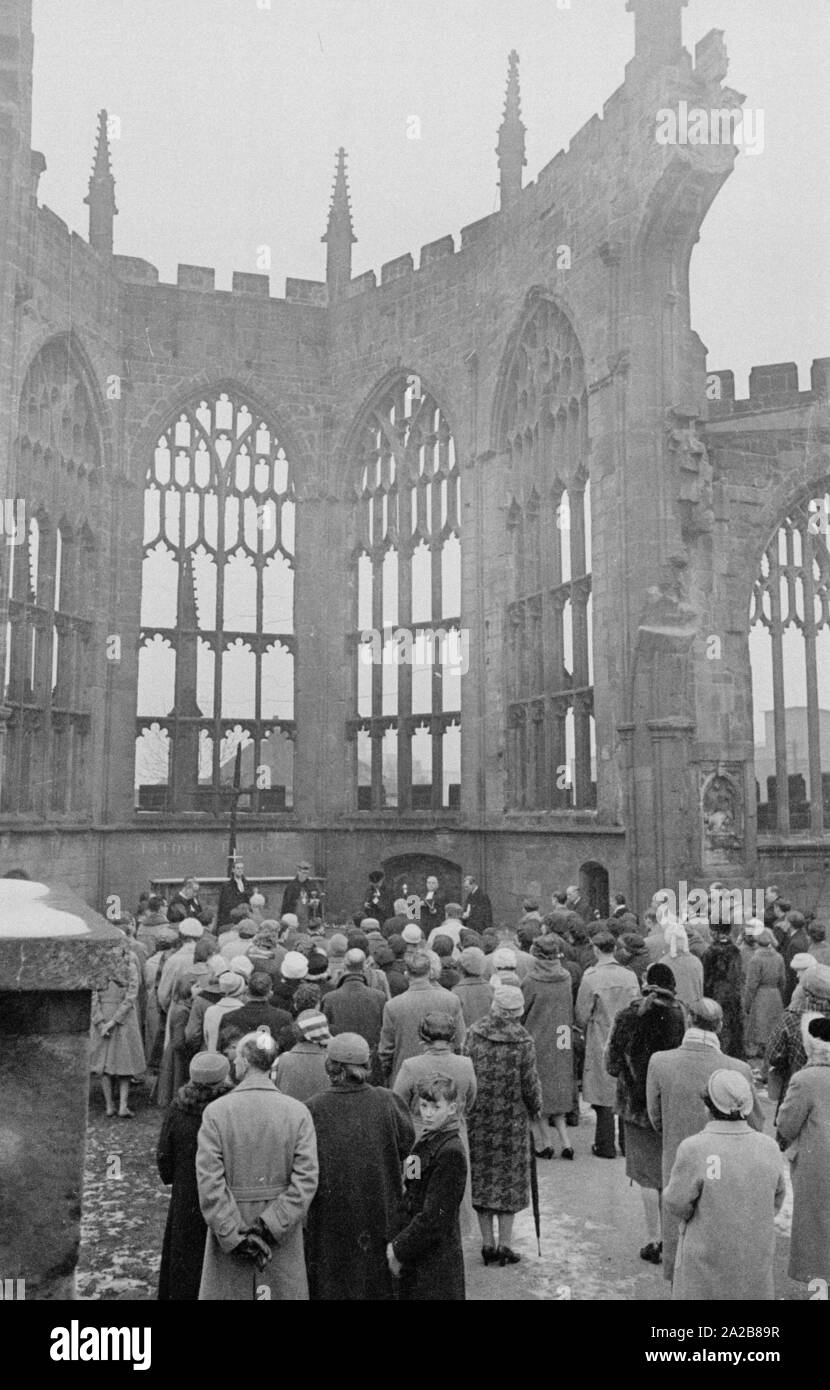 Believers have gathered in the ruin of St Michael's Cathedral in Coventry, destroyed by the Germans in World War II, to attend the laying of the foundation stone of the 'International Center for Reconciliation'. German Bishop Otto Dibelius traveled to Coventry for the festive occasion. Stock Photo