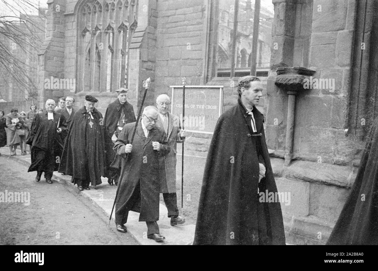 The German bishop, Otto Dibelius (with black beret), participates at the groundbreaking ceremony  of the 'International Center for Reconciliation' in the ruin of the destroyed St Michael's Cathedral. On the right, Reverend Bill Williams, the pastor of the destroyed cathedral. Stock Photo
