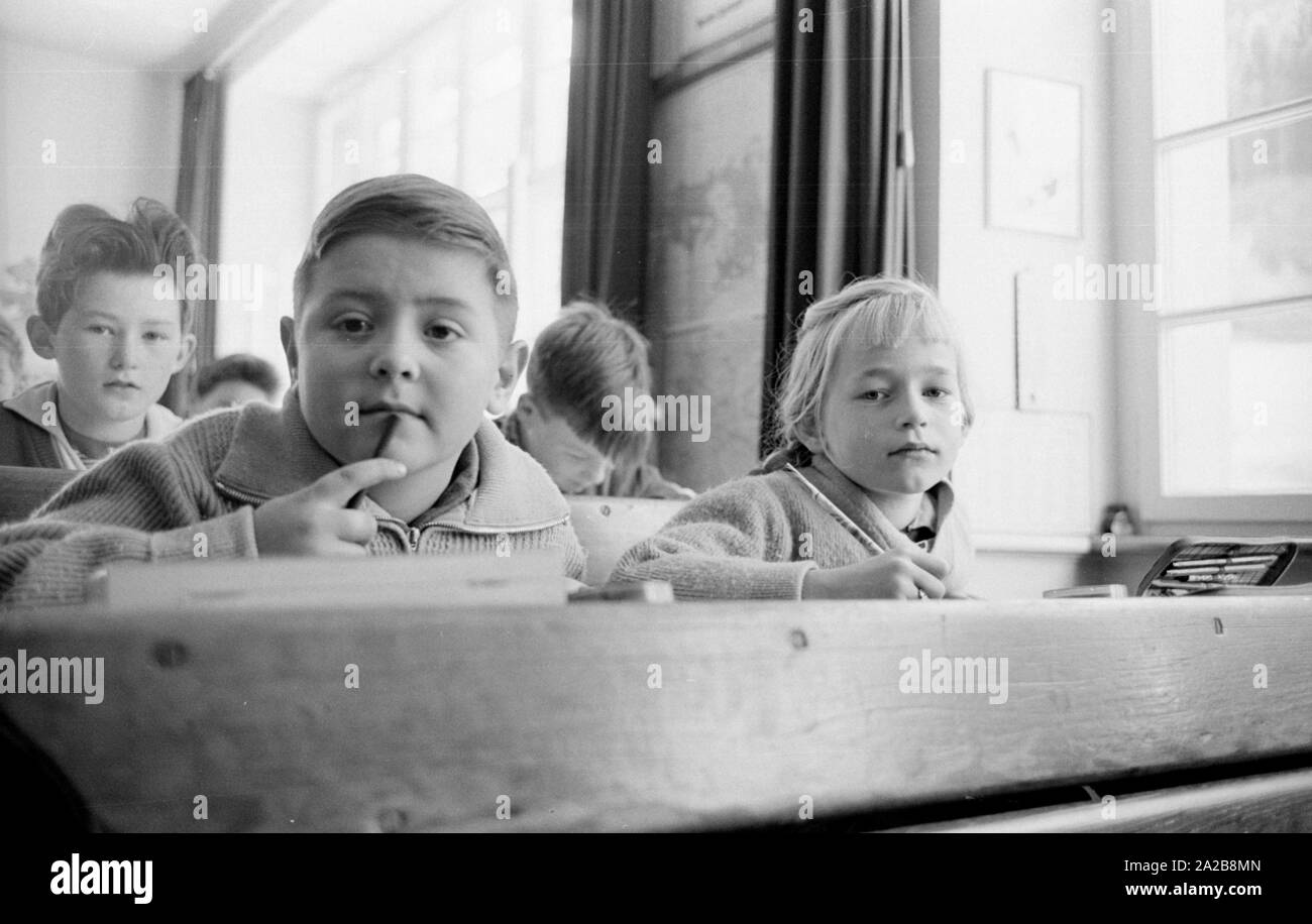 Schoolchildren during class in the village Zastler in the Black Forest. The photo was taken as part of a report on the village of Zastler, which was referred to as a 'Staatskolchose' (state collective farm) and led to discussions at the beginning of 1960. The background to the name is the fact that the majority of farms belonged to the state or the State Forestry Administration. Stock Photo