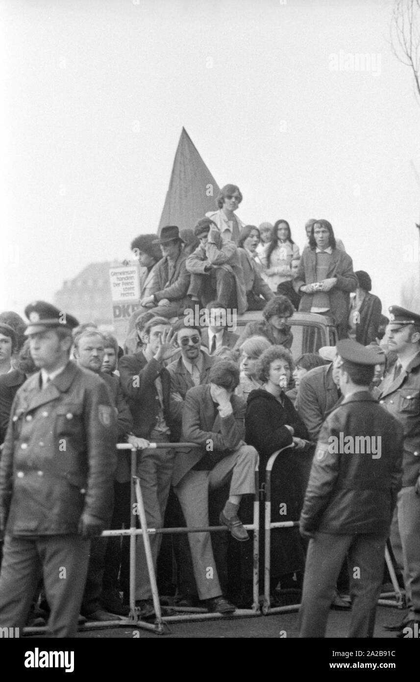 On 03.04.1971 the neo-Nazi party 'German People's Union' (today NPD) organized its first mass rally in Schwabinger Braeu in Munich, under the direction of the publisher Gerhard Frey.  There was a protest rally with leading politicians, a counter-demonstration and blockade of the building. In the picture: Protesters, also of the DKP, behind the cordon of the police. Stock Photo
