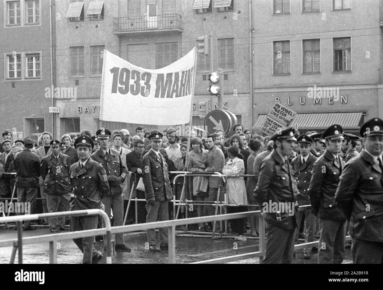 On 03.04.1971 the neo-Nazi party 'German People's Union' (today NPD) organized its first mass rally in Schwabinger Braeu in Munich, under the direction of the publisher Gerhard Frey.  There was a protest rally with leading politicians, a counter-demonstration and blockade of the building. Pictured: Protesters with the sign '1933 Remind' and 'Mayor Vogel: Left I'm shooting'. Stock Photo