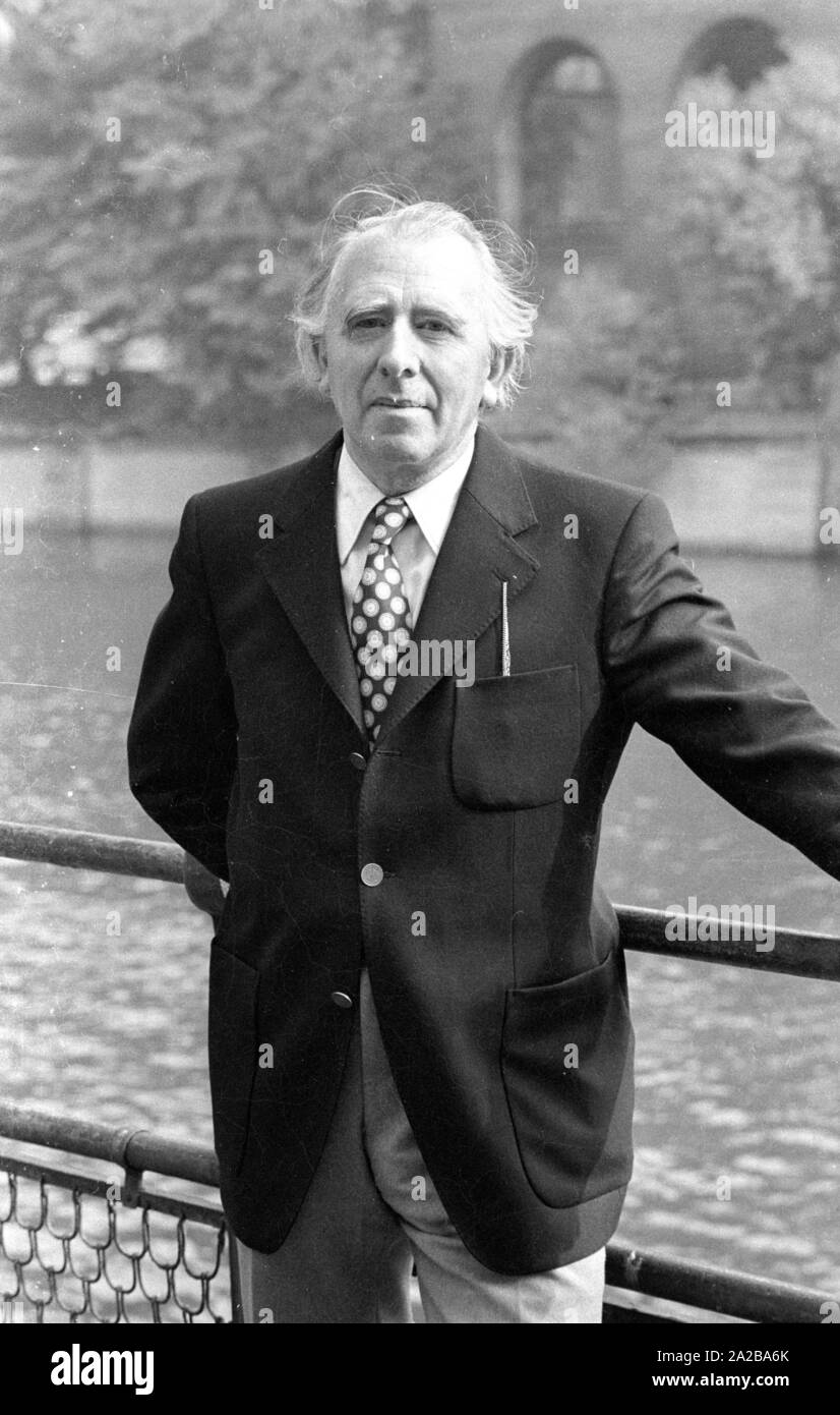 A man with dotted necktie is posing for a photo in front of the river Isar in Munich. Stock Photo