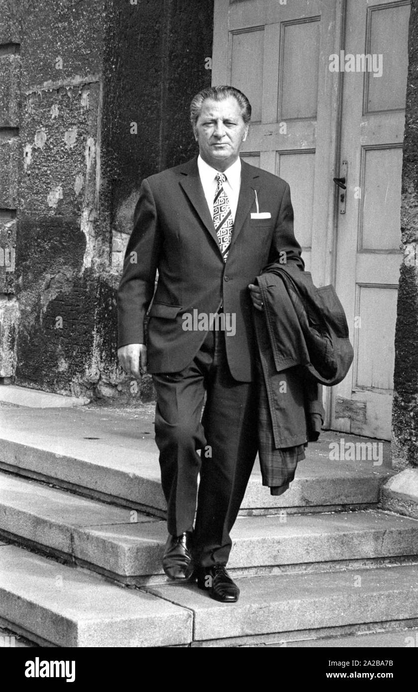 A man wears a patterned and striped tie to the dark suit. Stock Photo