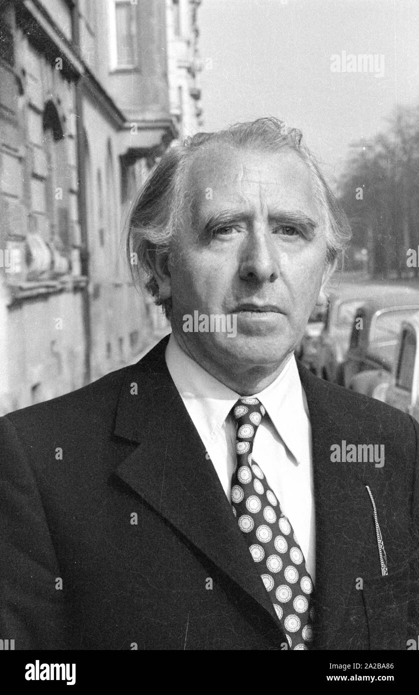 A man wearing a black tie with white dots with white shirt and black suit. Stock Photo