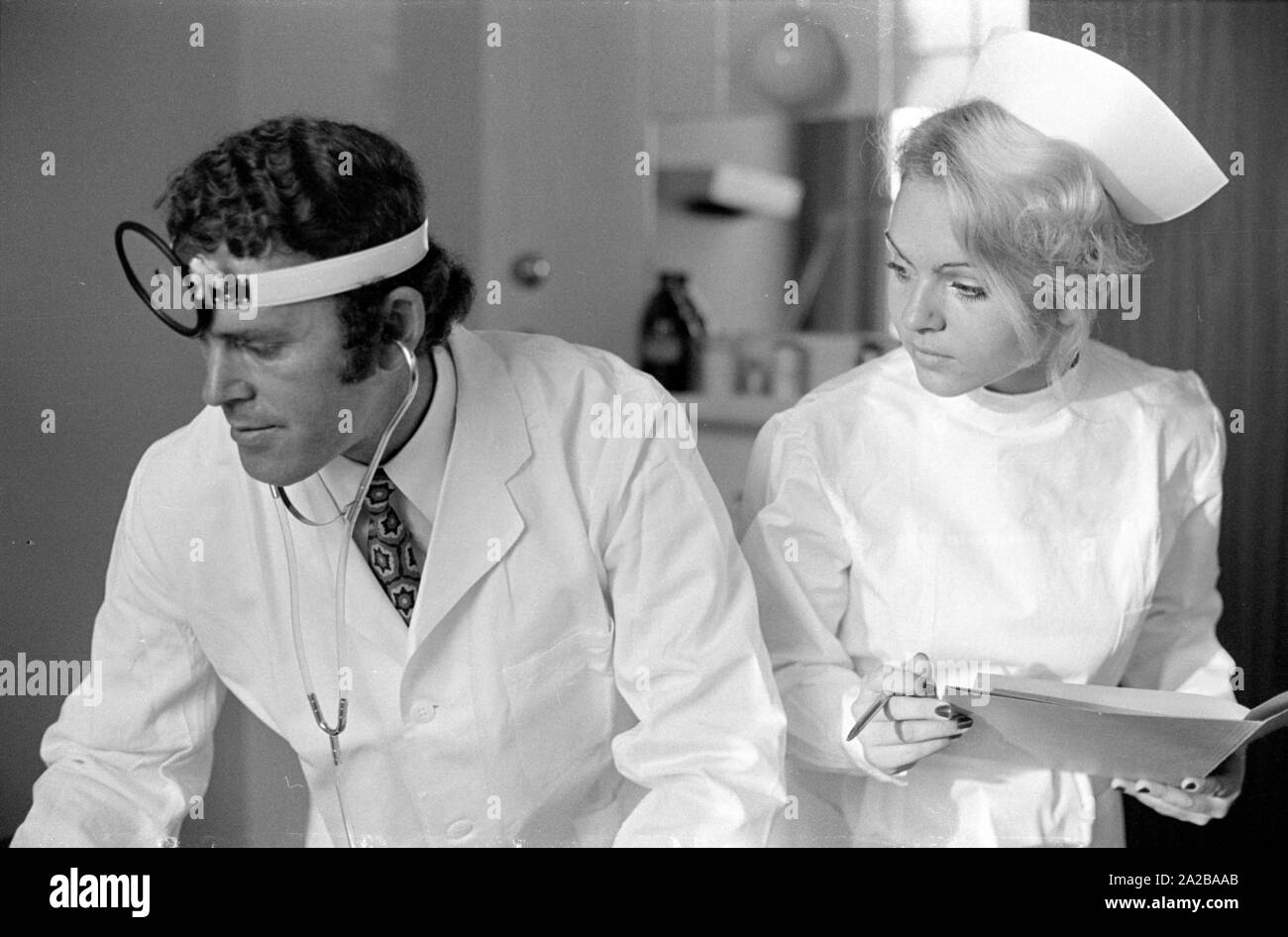 Doctor and nurse treat a patient together Stock Photo Alamy