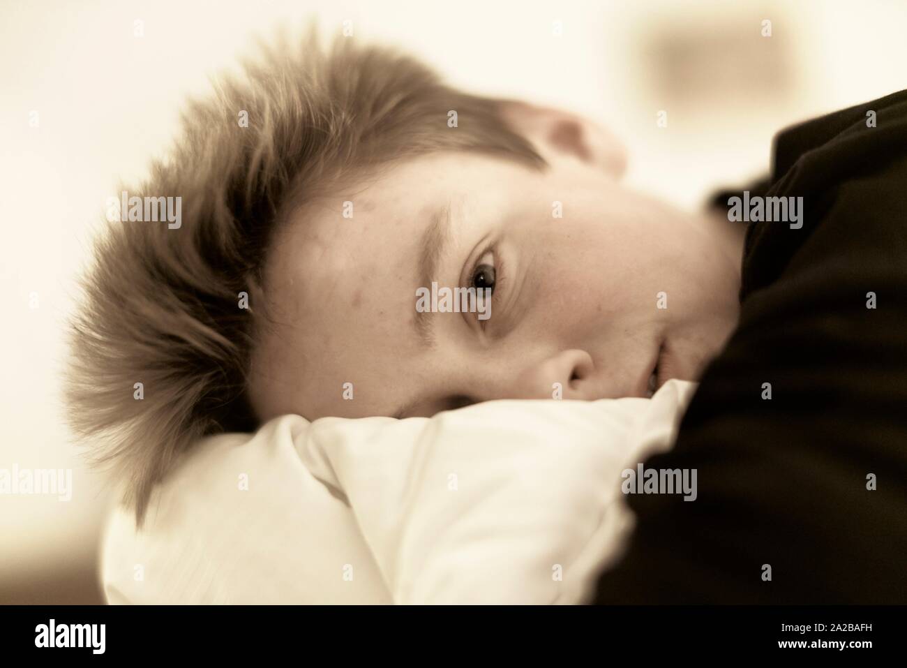 calm teenager (17 years) in bed, in Germany Stock Photo Alamy