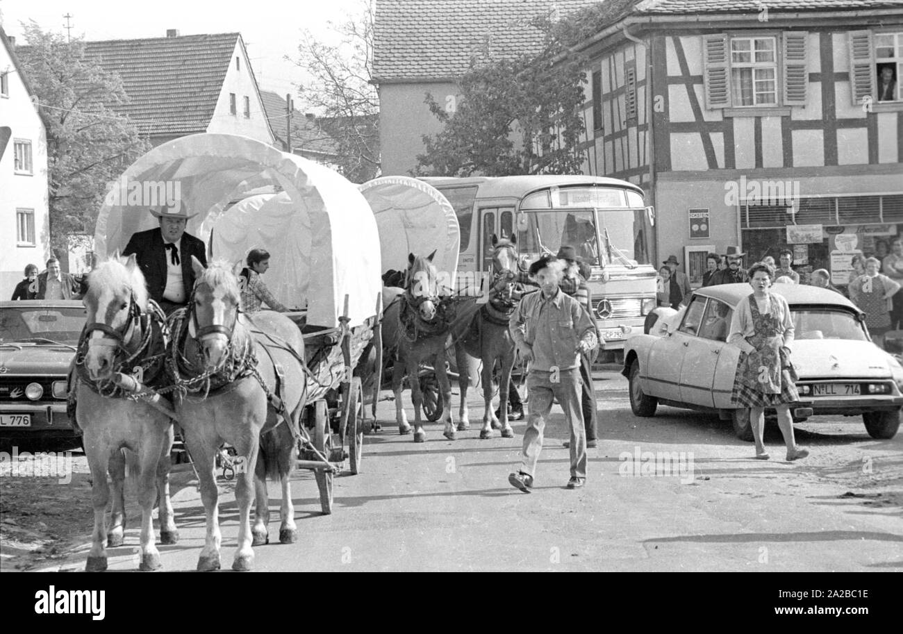 Adventure holiday with covered wagon in Upper Franconia: the wagons drive through a town. Stock Photo