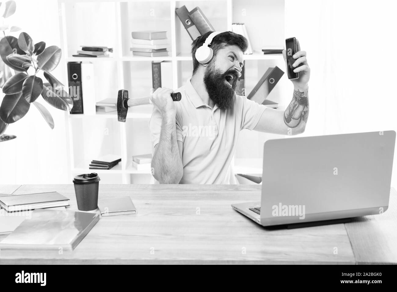 Incoming call. Most annoying thing about work in call center. Annoying client calling. Man bearded guy headphones office swing hammer on smartphone. Spoiled communication. Failed mobile negotiations. Stock Photo
