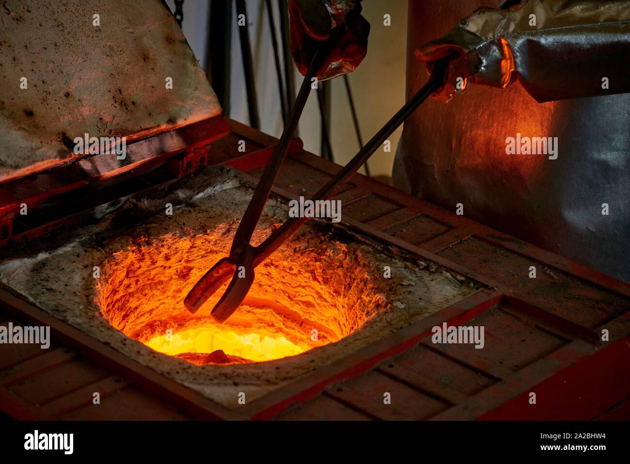 The artist is melting the bronze before filling the casting with with the hot metal Stock Photo - Alamy