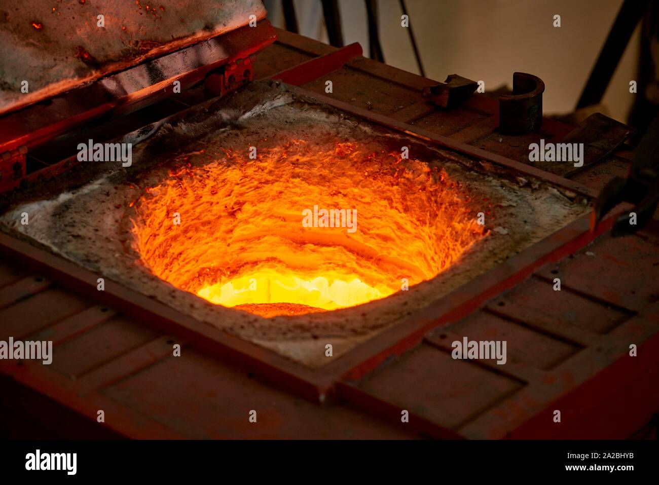 The artist is melting the bronze before filling the casting mold with
