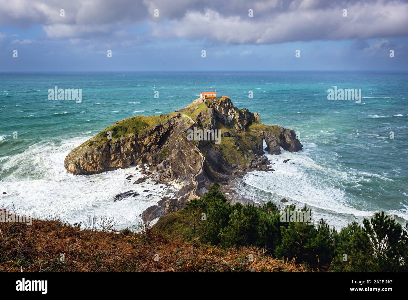 Aerial view with Gaztelugatxe islet with small San Juan hermitage on the coast of Biscay province of Spain. Stock Photo