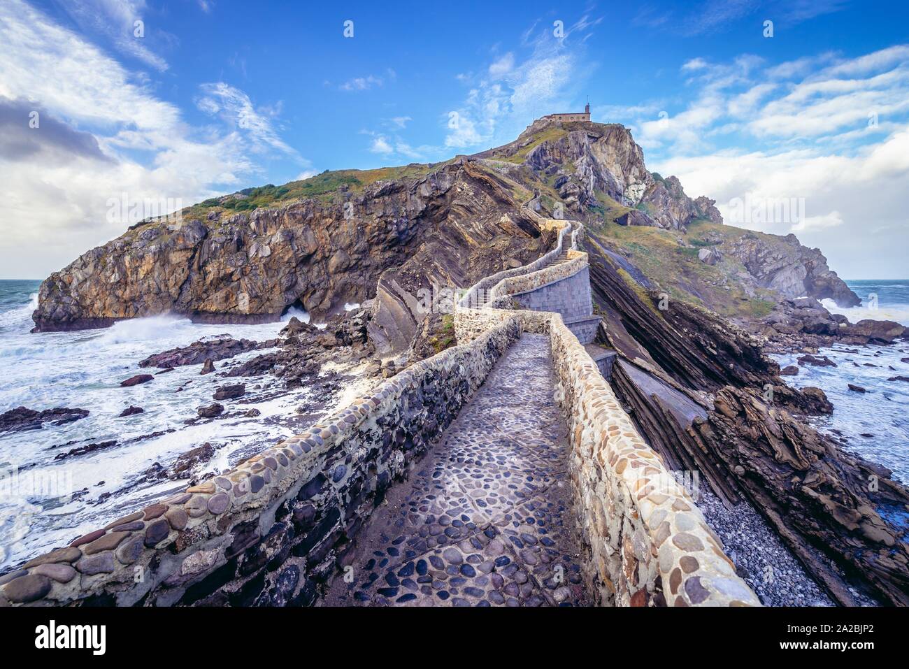 Bridge to hermitage on Gaztelugatxe islet in on the coast of Biscay province of Spain. Stock Photo