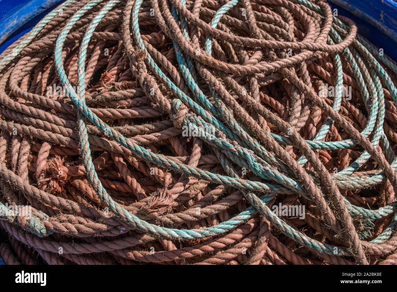 Plastic barrel full of fisher nylon ropes fishing port. Cabanas de Tavira, Portugal. Stock Photo