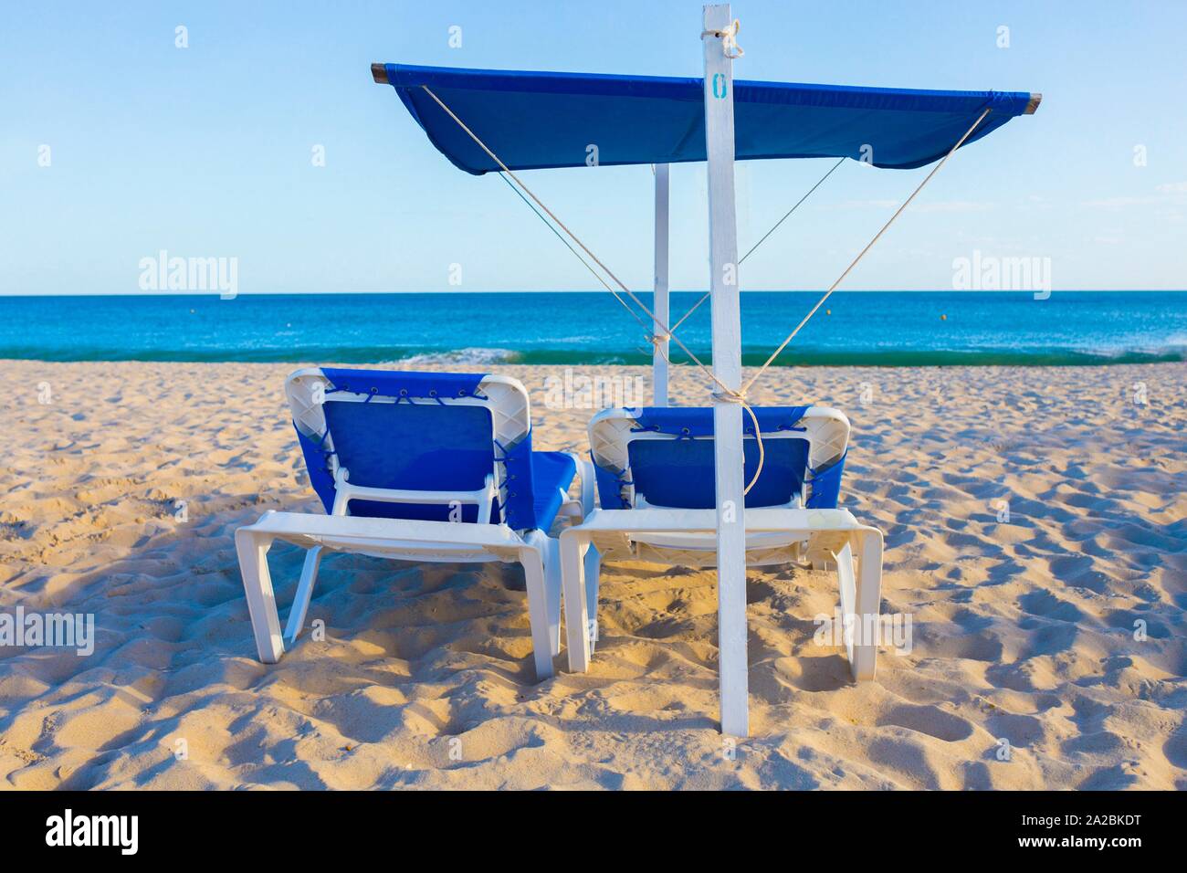 Beach chair with awning structure for sunshade. Beach background. Stock Photo