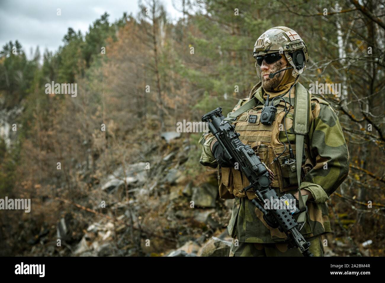 Norwegian Rapid reaction special forces FSK soldier patrolling in the  forest. Field camo uniforms, combat helmet and eye-wear goggles are on  Stock Photo - Alamy