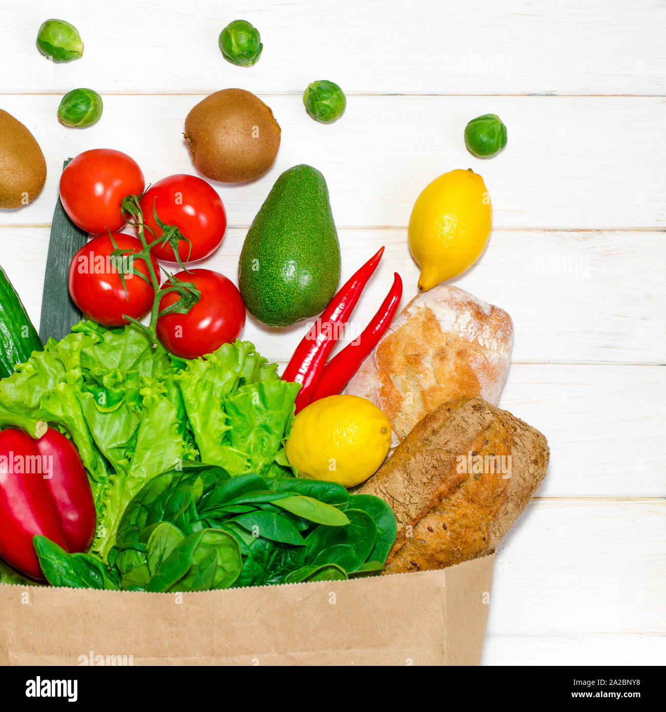 Paper bag of different health food on white wooden background. Top view ...