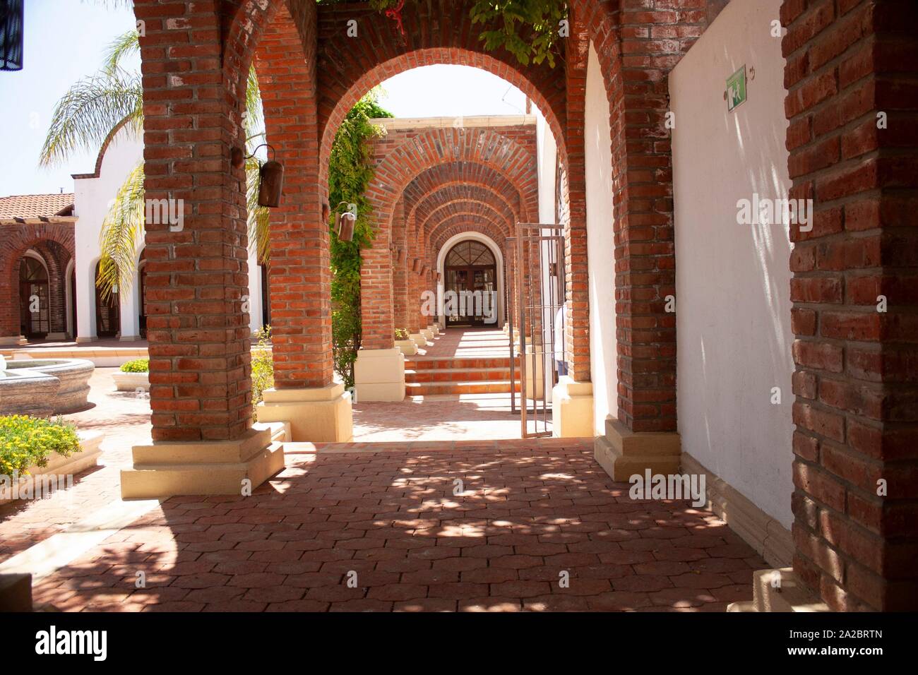 outdoors arches and columns of red bricks in the outskirts of the city of Baja California Mexico. Stock Photo