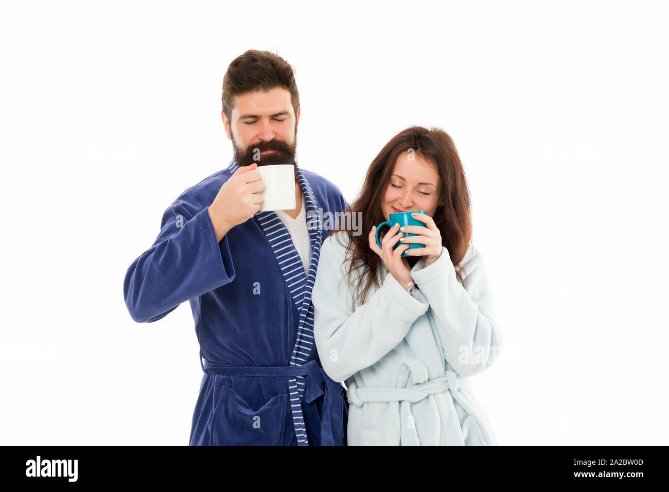 Couple enjoy lazy weekend and drink coffee. Man and woman wear
