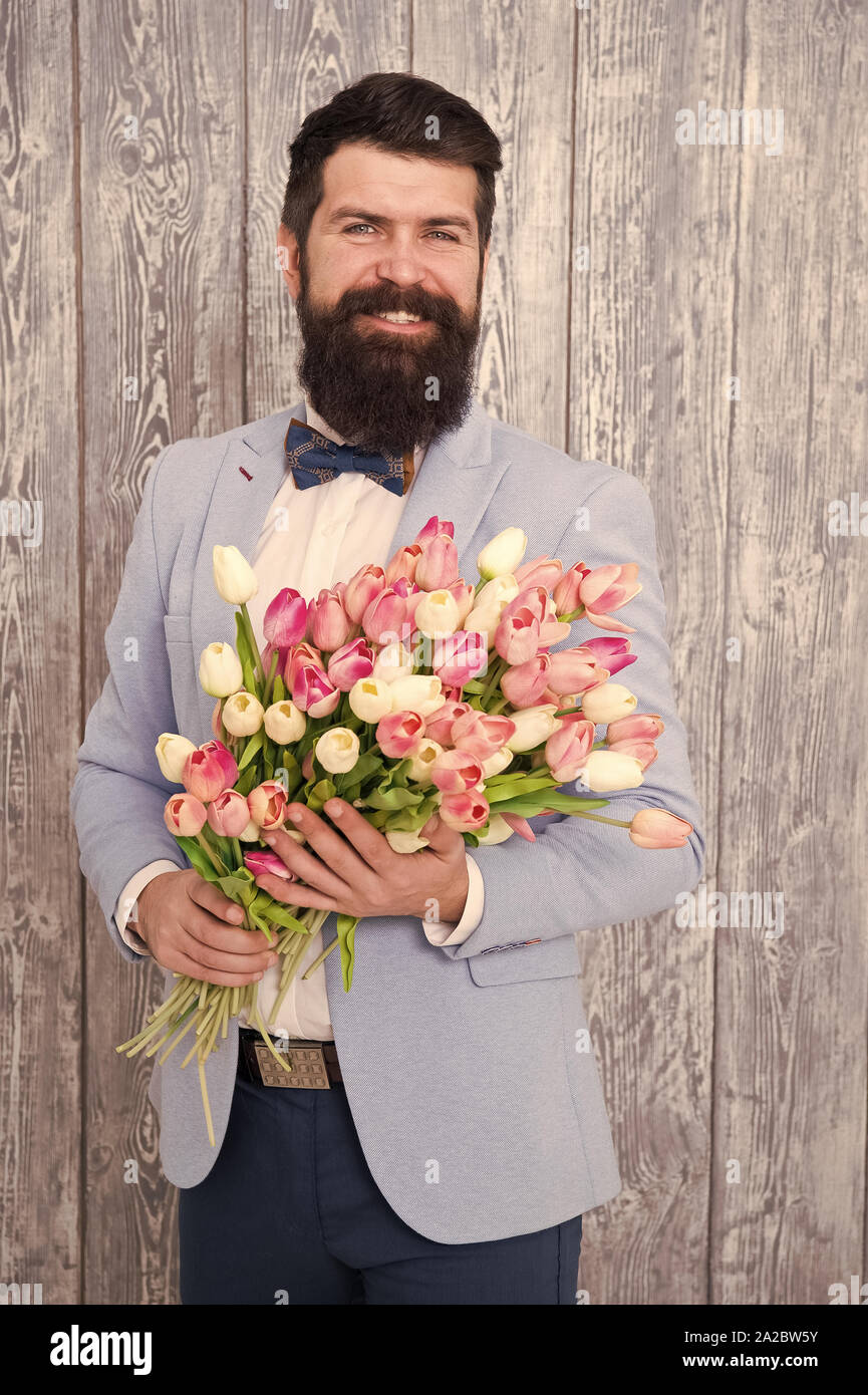 Unique flower arrangements. Spring gift. Bearded man hipster with flowers.  Flower for March 8. Love date. international holiday. Womens day. Bearded  man with tulip bouquet. Spring flower bouquet Stock Photo - Alamy, image size:865x1390