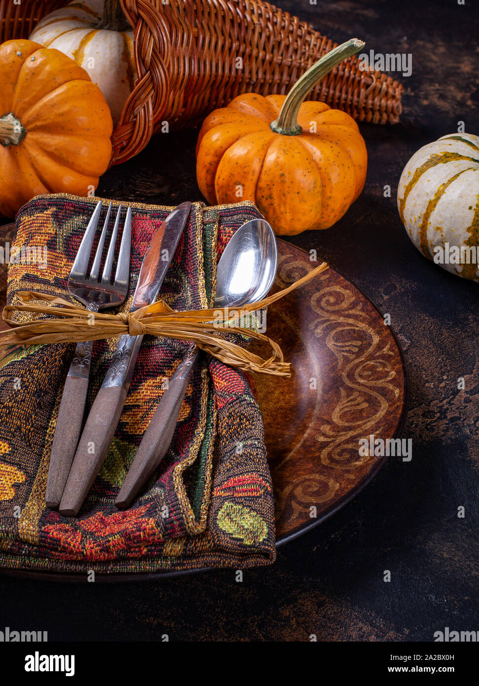 Autumn place setting and mini pumpkins on a rustic wooden table Stock Photo