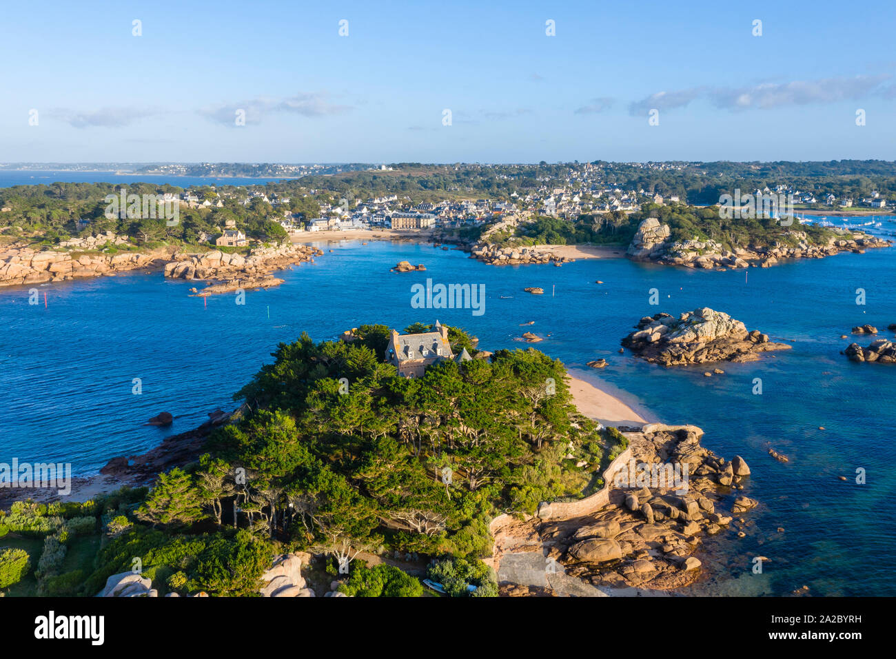 France, Cotes d'Armor, Cote de granit rose (Pink Granite Coast), Tregastel, Saint Guirec cove with Costaeres island and castle in the foreground (aeri Stock Photo