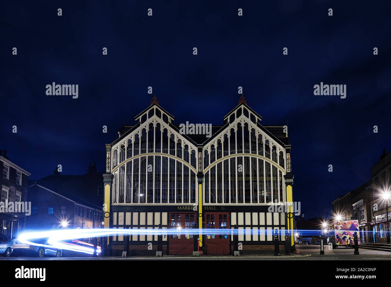 Market Hall at night, with light trails from passing cars in Stockport, North West England Stock