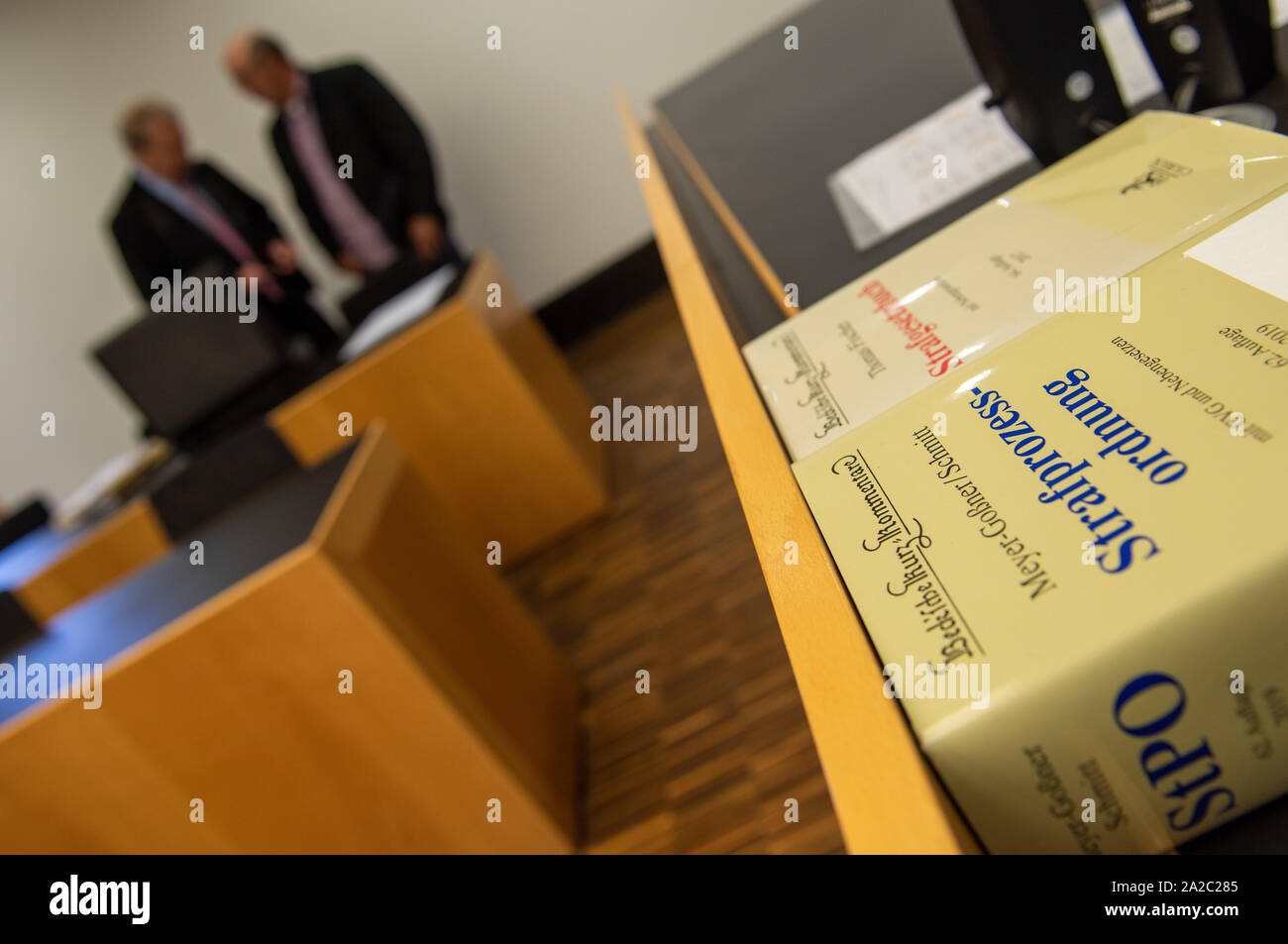 Augsburg, Germany. 02nd Oct, 2019. The defendant (r) converses with his lawyer in the courtroom. He is said to have shot two poachers in front of the owner. He was sentenced to 90 daily rates for damage to property, punishable animal slaughter and negligent bodily injury. Credit: Stefan Puchner/dpa/Alamy Live News Stock Photo