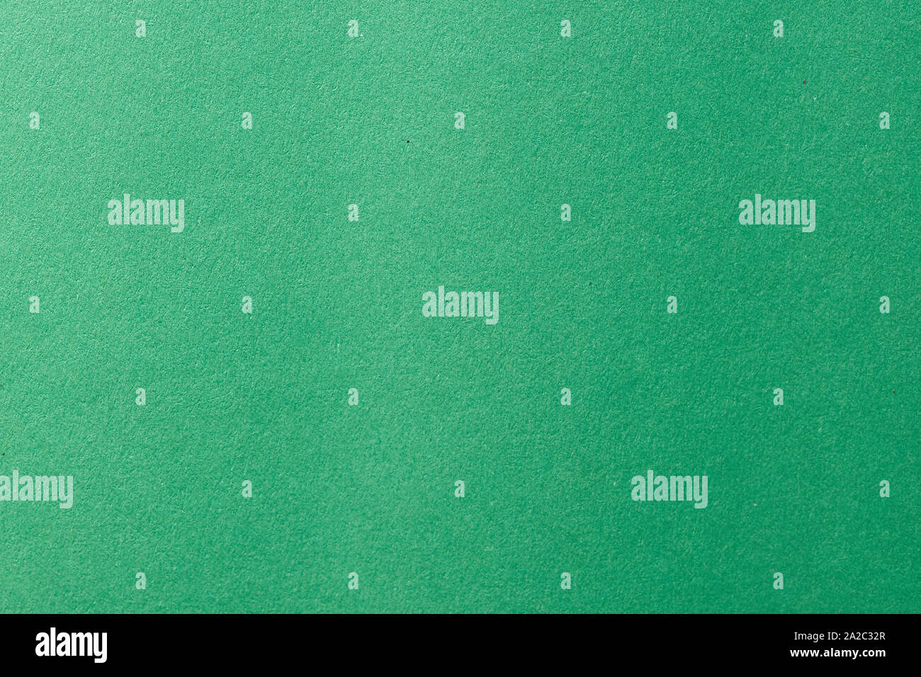 Clean green paper texture with simple surface. High resolution photo. Color paper, light green