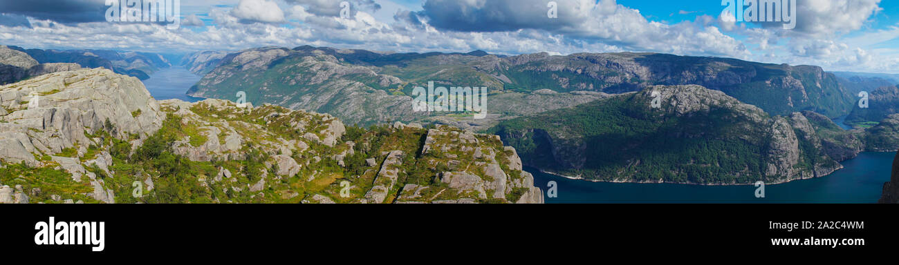 Panoramic view from the top of Preikestolen fjords. Lake below and between fjords in valley Stock Photo